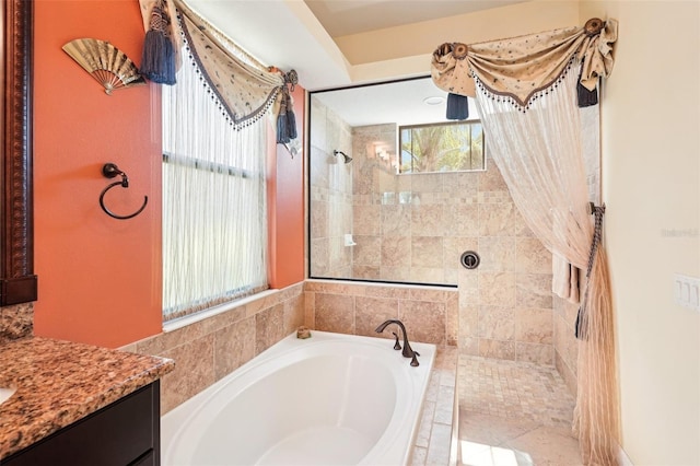 bathroom with a bath, vanity, and walk in shower