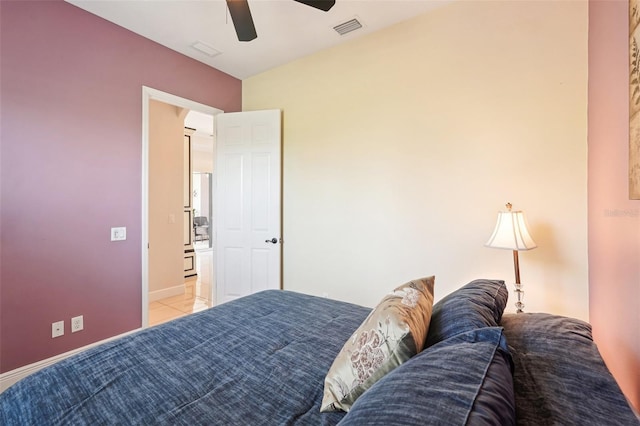 bedroom featuring light tile patterned flooring, visible vents, baseboards, and ceiling fan