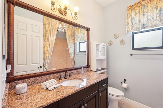 full bath featuring vanity, baseboards, an inviting chandelier, tile patterned floors, and toilet