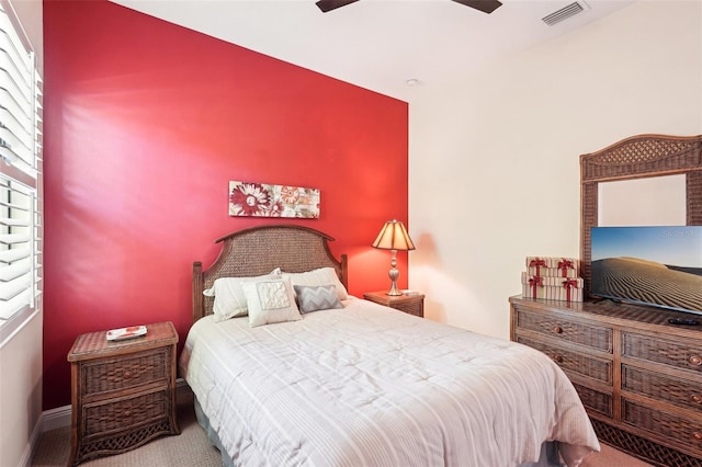 bedroom featuring visible vents, carpet flooring, baseboards, and a ceiling fan