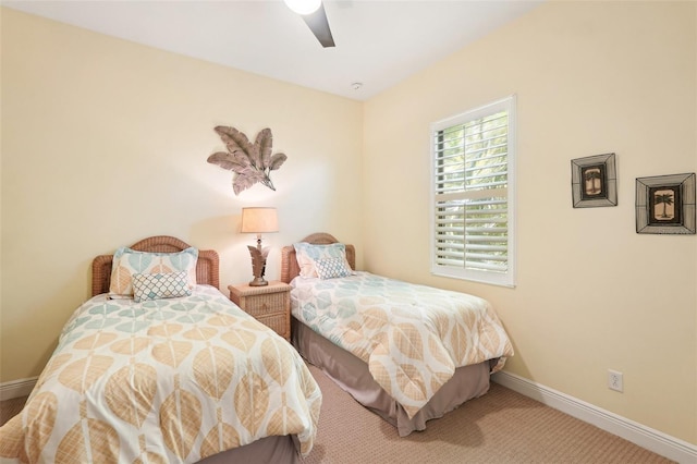 carpeted bedroom featuring a ceiling fan and baseboards