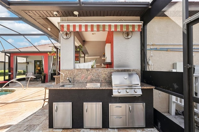 view of patio / terrace featuring glass enclosure, area for grilling, and a sink