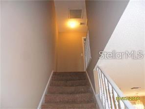 staircase with visible vents and baseboards