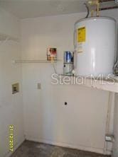 clothes washing area featuring water heater