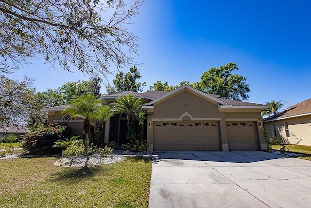 ranch-style house with stucco siding, driveway, a front yard, and an attached garage