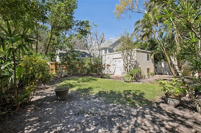 view of yard with an outbuilding and a fenced backyard