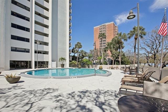 community pool with a patio area