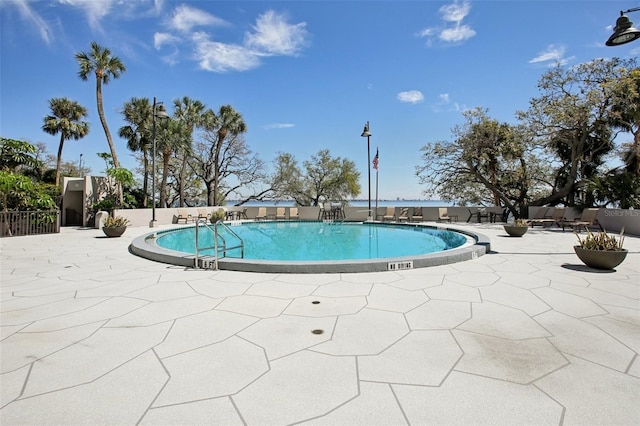 community pool featuring a patio area and fence