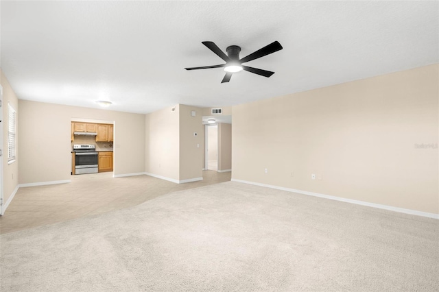 unfurnished living room featuring baseboards, a ceiling fan, visible vents, and light carpet