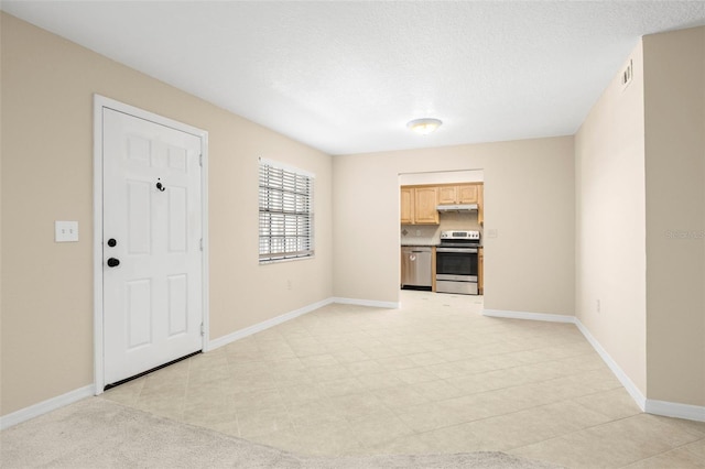 interior space with visible vents, baseboards, and a textured ceiling