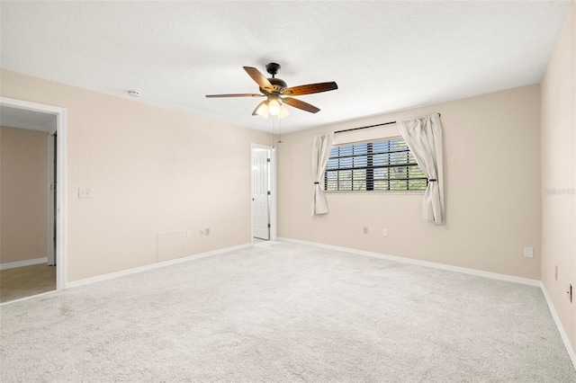 unfurnished room featuring baseboards, a textured ceiling, ceiling fan, and carpet flooring