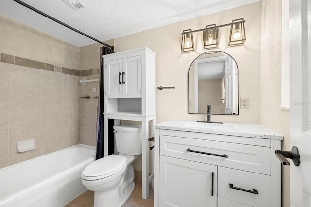 full bathroom featuring visible vents, toilet, shower / bath combo with shower curtain, a textured ceiling, and vanity