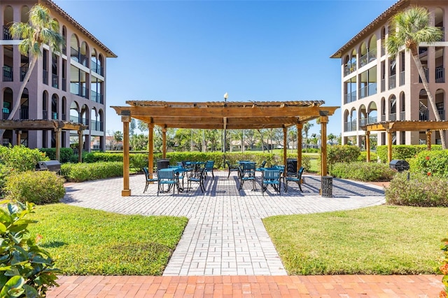 view of community with a pergola and a yard