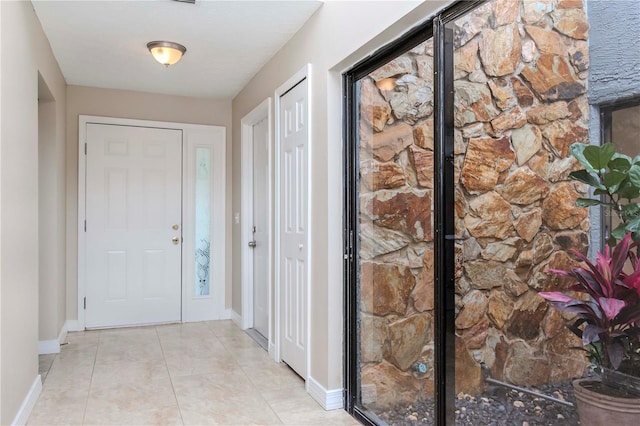 14501 Brambie Ct, Tampa, FL 33624 - foyer entrance featuring light tile patterned flooring and baseboards
