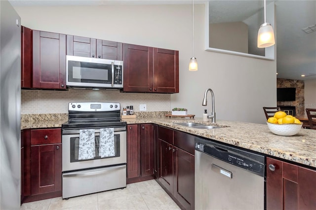 14501 Brambie Ct, Tampa, FL 33624 - kitchen featuring a sink, stainless steel appliances, dark brown cabinets, and light tile patterned floors