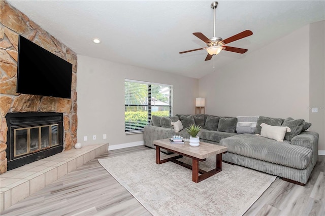14501 Brambie Ct, Tampa, FL 33624 - living room featuring a ceiling fan, vaulted ceiling, a fireplace, and wood finished floors
