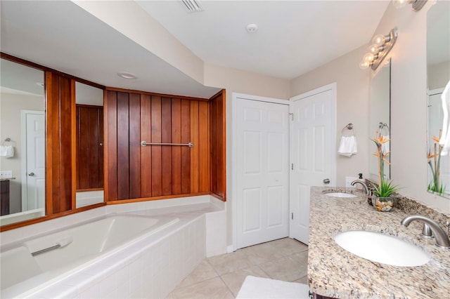 14501 Brambie Ct, Tampa, FL 33624 - full bath with tile patterned floors, a bath, double vanity, and a sink