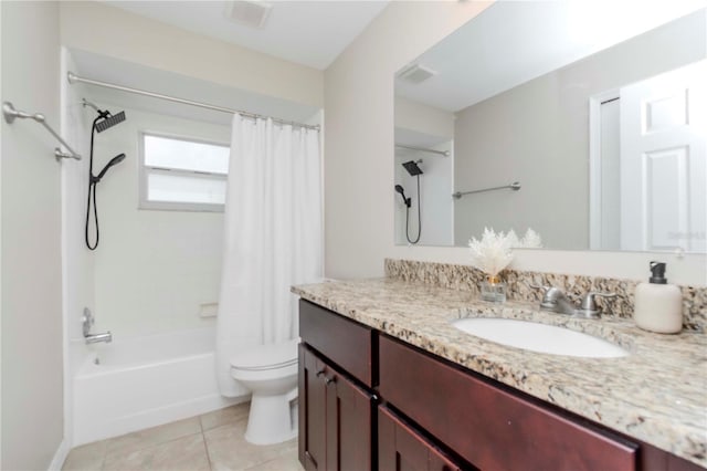 14501 Brambie Ct, Tampa, FL 33624 - bathroom with vanity, toilet, tile patterned floors, visible vents, and shower / bath combo