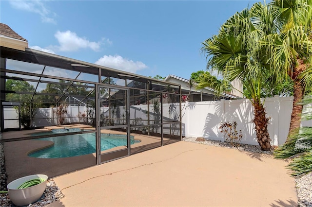 14501 Brambie Ct, Tampa, FL 33624 - view of swimming pool with a fenced backyard, a fenced in pool, glass enclosure, a jacuzzi, and a patio area