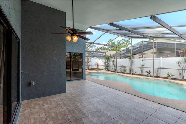 14501 Brambie Ct, Tampa, FL 33624 - view of swimming pool with glass enclosure, a patio, and a fenced in pool