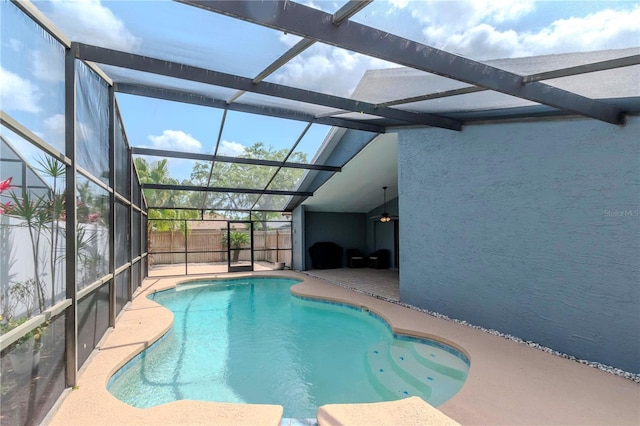 14501 Brambie Ct, Tampa, FL 33624 - view of swimming pool featuring glass enclosure, a patio area, and a fenced in pool