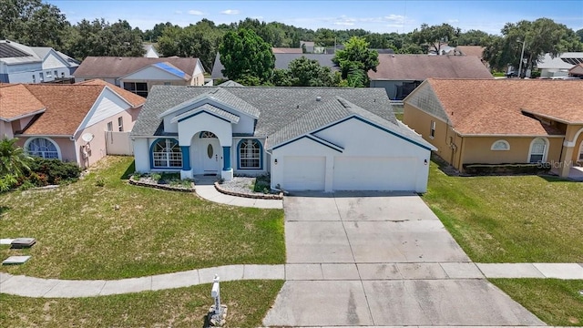 view of front of home featuring a front lawn, an attached garage, a residential view, and stucco siding