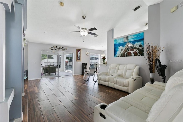 living room with a ceiling fan, wood finish floors, visible vents, and baseboards