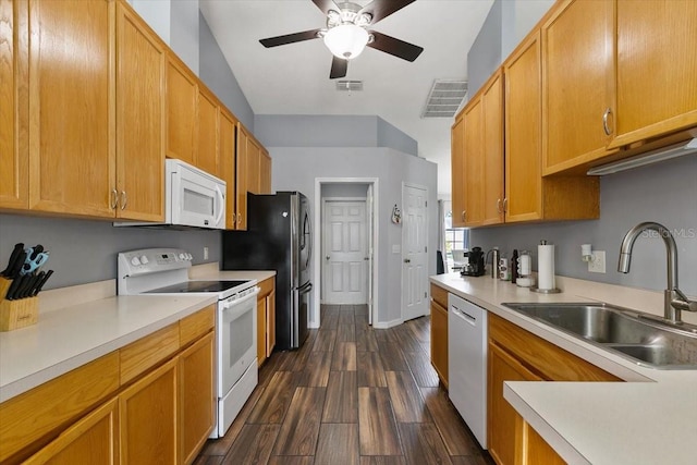 kitchen featuring light countertops, white appliances, a sink, and dark wood finished floors