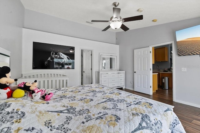 bedroom with dark wood-style floors, ceiling fan, visible vents, and baseboards