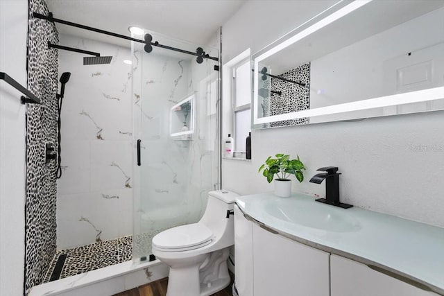 full bathroom featuring toilet, vanity, and a marble finish shower