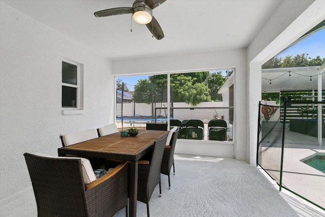 sunroom featuring ceiling fan