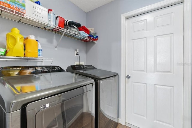 laundry room with laundry area, wood finished floors, and independent washer and dryer