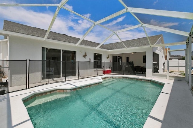 view of swimming pool featuring a fenced in pool, glass enclosure, a patio area, and fence