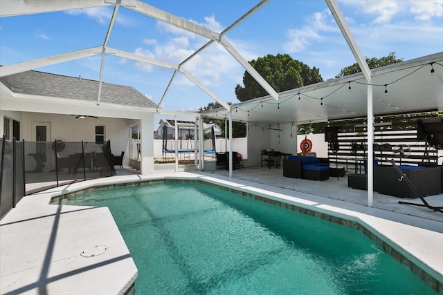 view of pool featuring a patio, outdoor lounge area, fence, a fenced in pool, and a trampoline