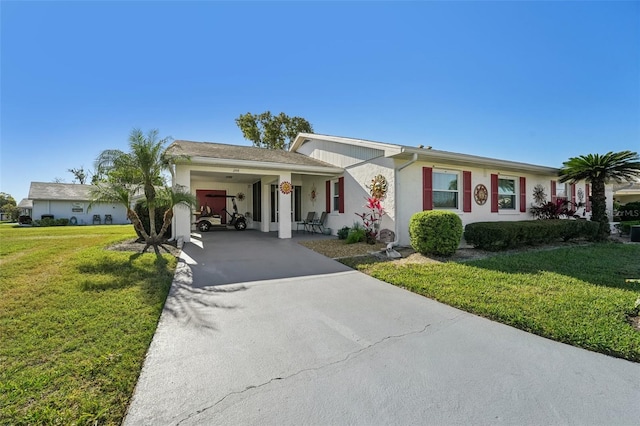 ranch-style house featuring stucco siding, a carport, concrete driveway, and a front lawn