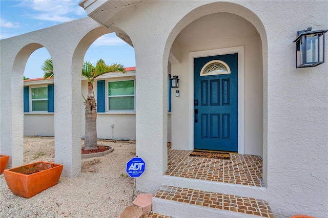 entrance to property featuring stucco siding