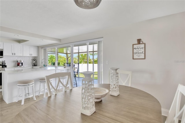 dining room with light wood-style flooring