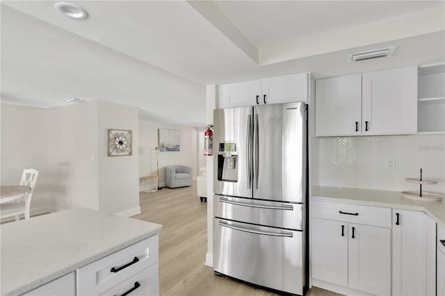 kitchen featuring open shelves, backsplash, light wood-style flooring, white cabinetry, and stainless steel fridge with ice dispenser