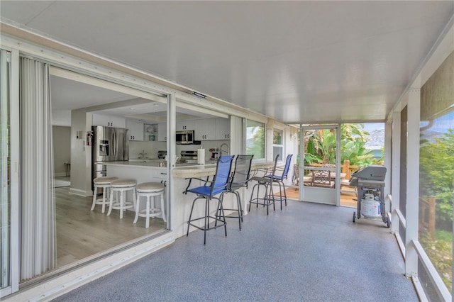 sunroom / solarium with a sink