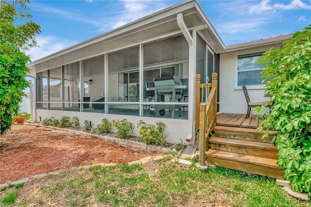 view of side of home featuring a sunroom