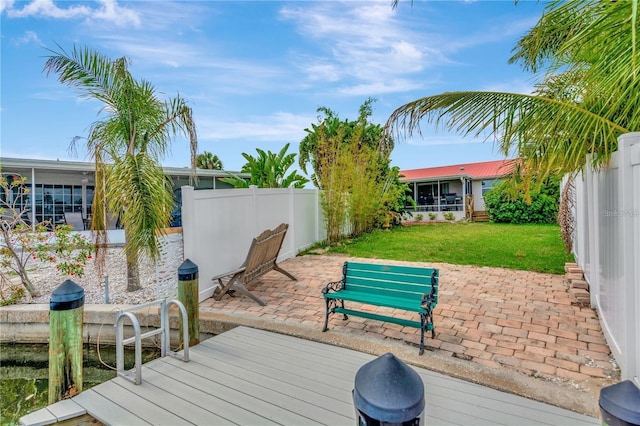 wooden deck with a patio area, a fenced backyard, and a yard