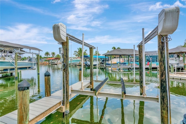 dock area with a water view and boat lift