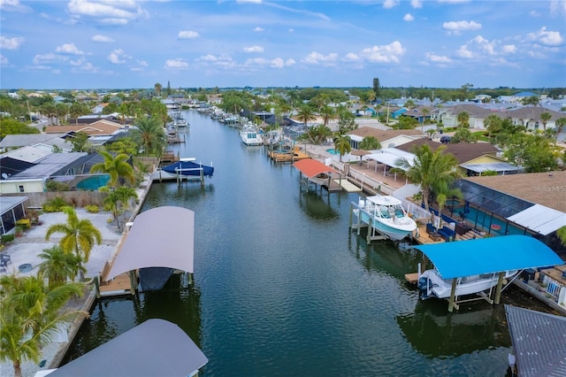 birds eye view of property with a water view and a residential view