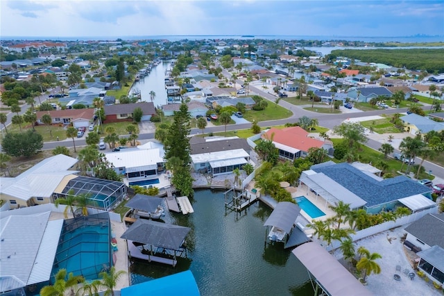 birds eye view of property with a water view and a residential view