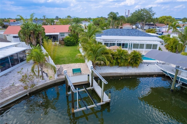 exterior space with a water view, a yard, and boat lift