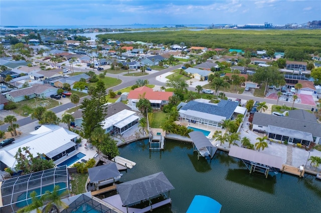 drone / aerial view with a water view and a residential view