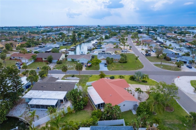 birds eye view of property featuring a water view and a residential view