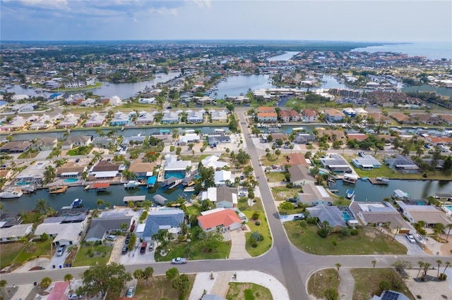 drone / aerial view featuring a water view and a residential view