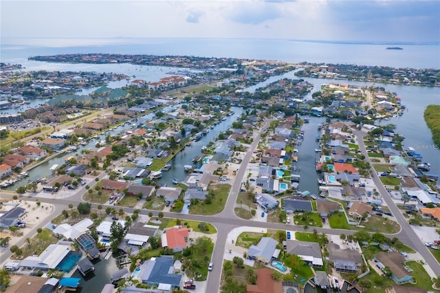 drone / aerial view featuring a residential view and a water view