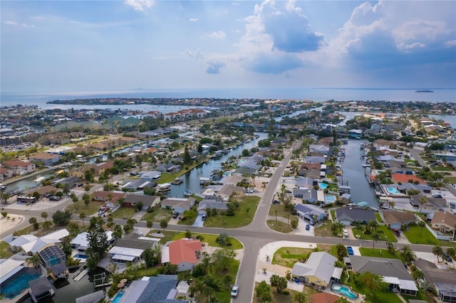 drone / aerial view featuring a water view and a residential view